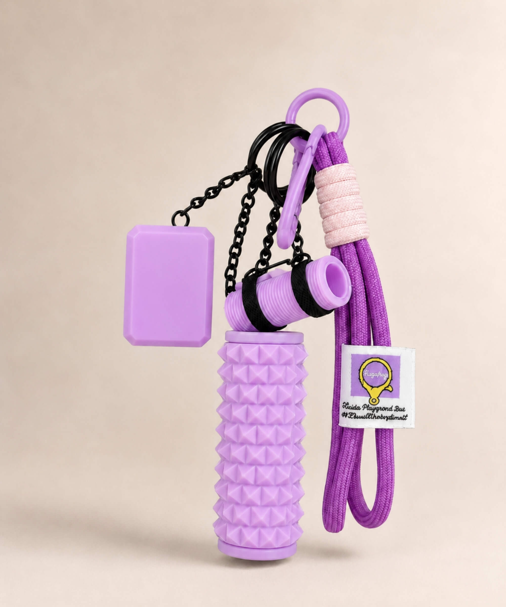 Purple yoga rope keychain with mini foam roller charm on a neutral background